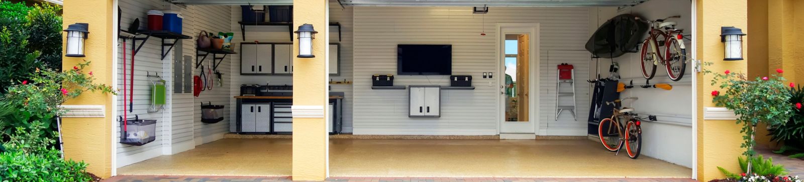 Spacious, clean three-car garage in Casselberry, FL, featuring custom wall storage, mounted bikes, a workbench, and neatly organized shelving.